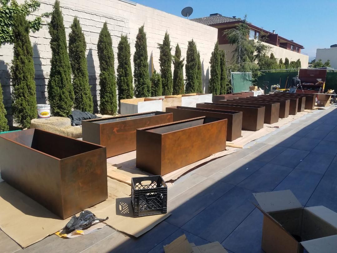 Planters with a faux oxidized rustic metal finish